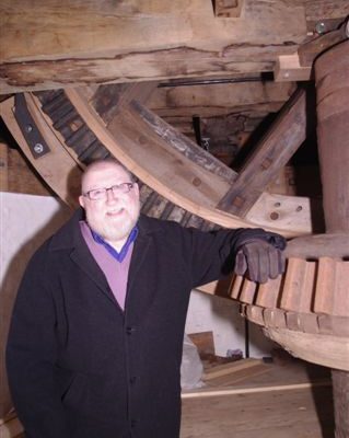 Bob Anderton beside the machinery of Holgate Windmill