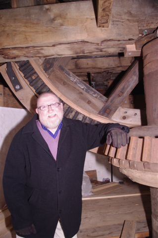 Bob Anderton beside the machinery of Holgate Windmill